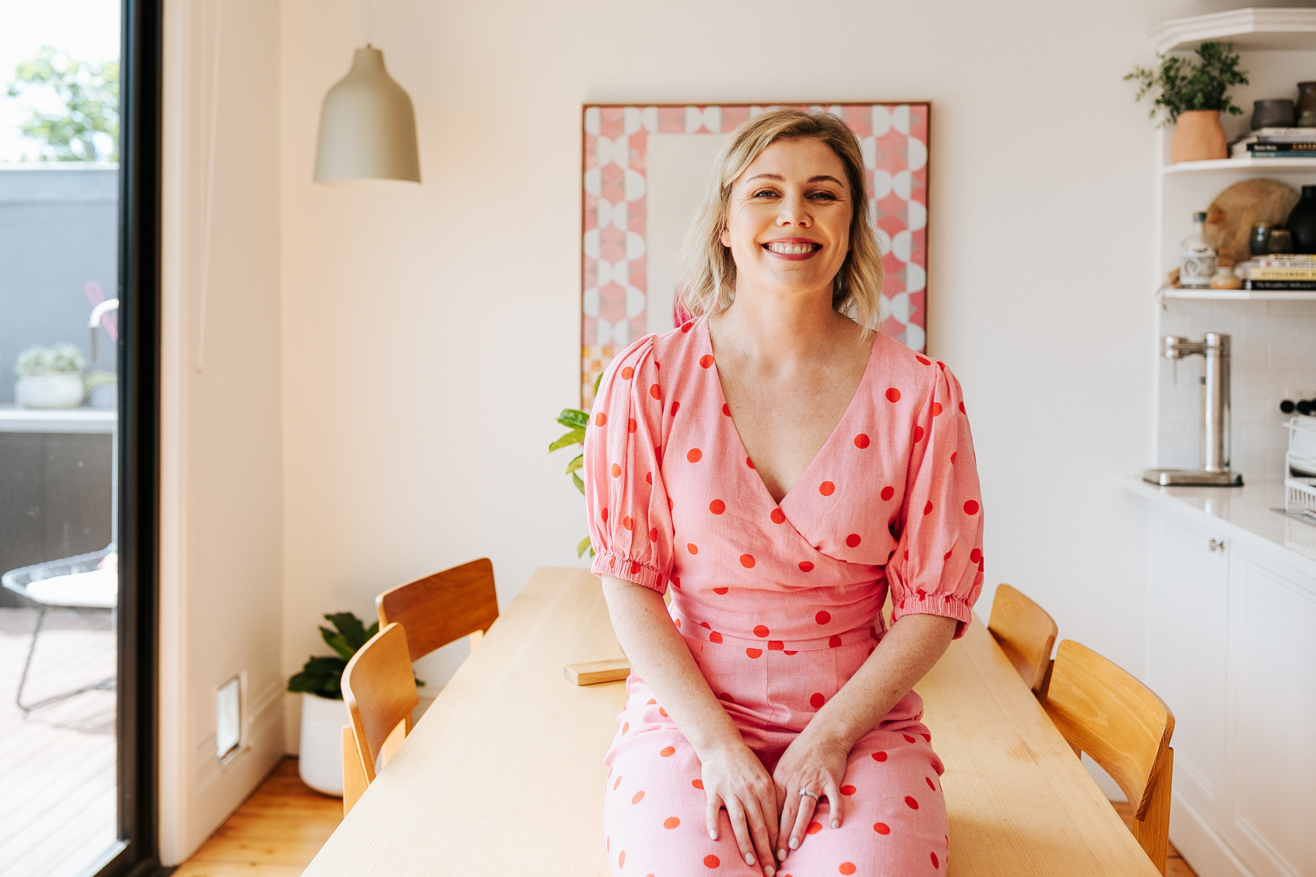 Amanda smiling at her dining table